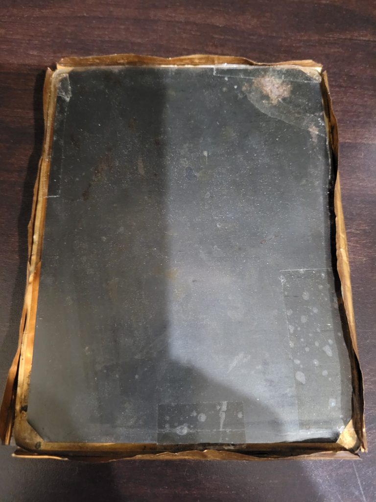 Here you can see how someone used packing tape to secure the tintype image into the copper frame. Finding things like this makes me an Angry Archivist...please don't do this!