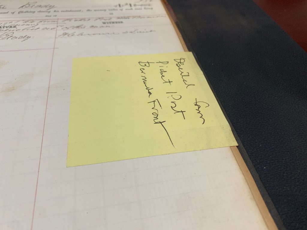 Here's an example of a sticky note stuck to an original page of a ledger making note of a deserter. Something that it literally says in red ink just a few inches away from the sticky note. This note is not providing any additional information from what is already plainly visible on the page, and it is actively causing damage to the original pages because it is non-archival.