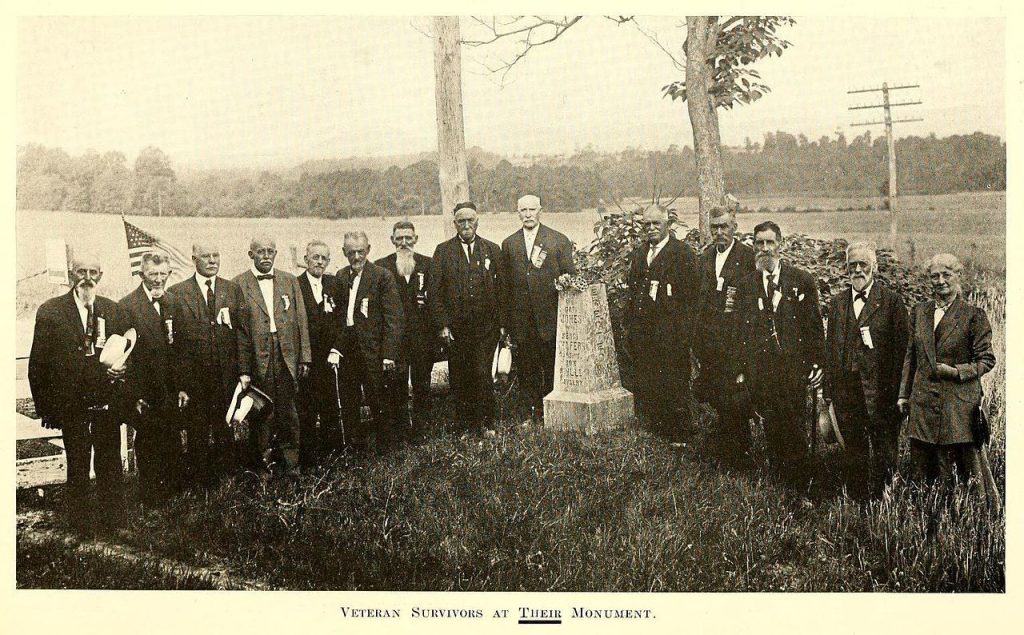 Veterans of the 8th Illinois Cavalry pose with the marker commemorating the first shot fired at Gettysburg during the 50th anniversary reunion, July 1913.