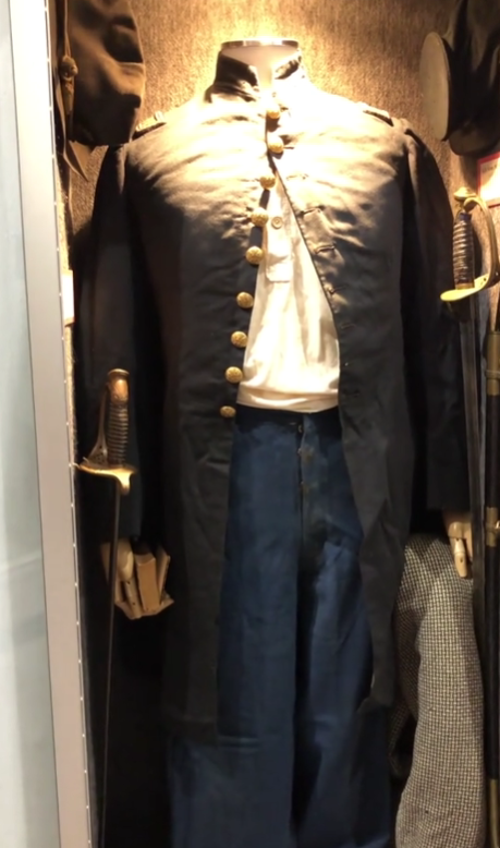 This is a screenshot of a TikTok video I found that shows a Civil War uniform exhibited on a mannequin that is too large. Notice how it cannot be fully buttoned. By buttoning the top two buttons, you can see the stress put on the garment because those two buttons are trying to hold the whole thing together. This is an example of why it is important to use a mannequin that fits your garment, and why it's better to work with one that's on the slightly too small side and pad it up.